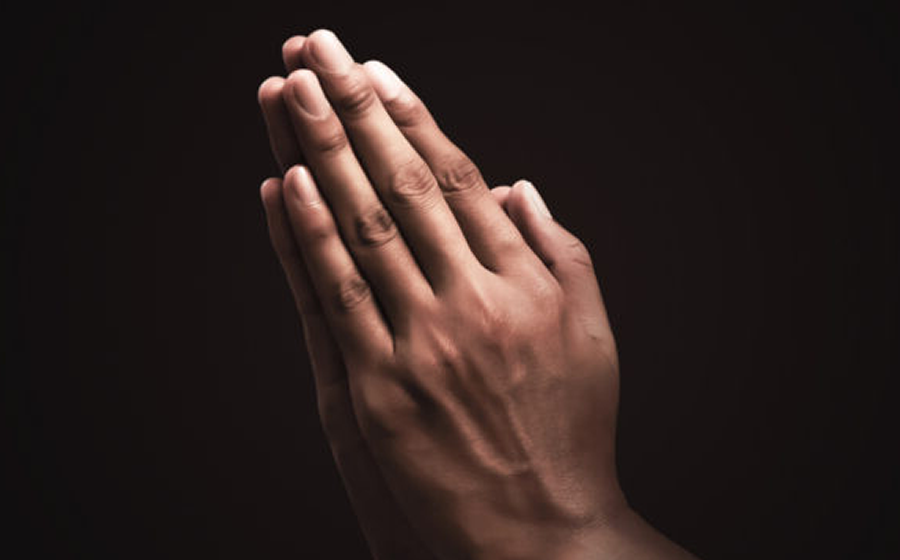 A lit candle representing prayer